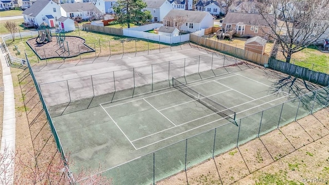 view of sport court featuring a residential view and fence