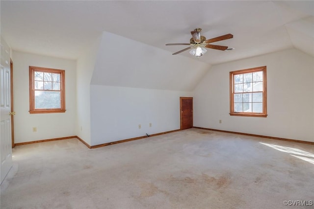 bonus room featuring lofted ceiling, carpet flooring, and a healthy amount of sunlight