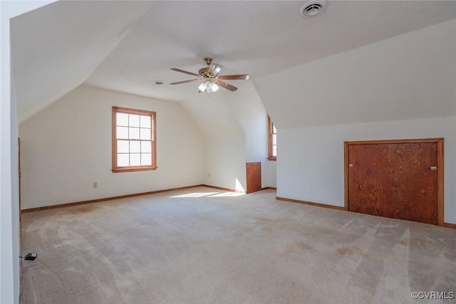 additional living space featuring visible vents, ceiling fan, baseboards, carpet, and lofted ceiling