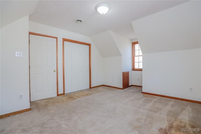 bonus room with lofted ceiling, carpet, baseboards, and visible vents