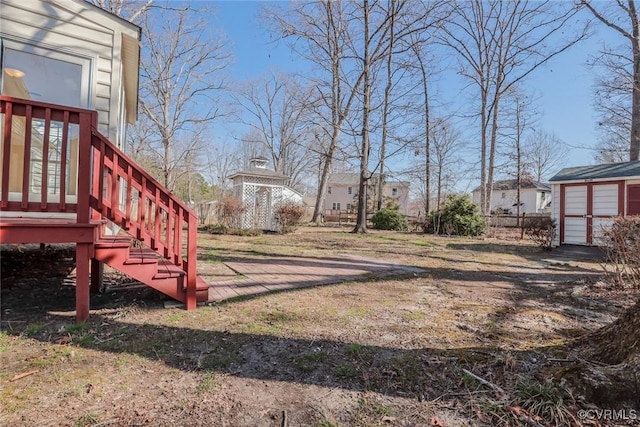 view of yard with stairway and an outbuilding