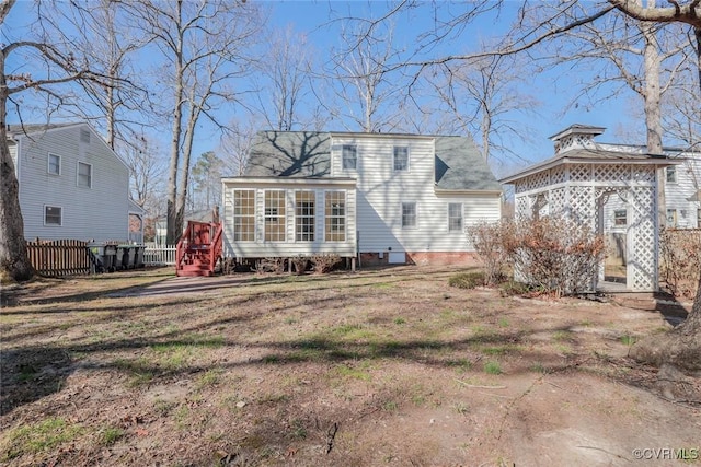 back of house featuring a gazebo and fence