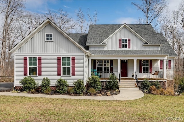 view of front of home featuring covered porch, board and batten siding, a shingled roof, and a front lawn