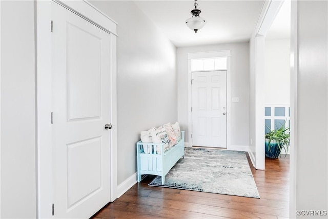 entryway featuring baseboards and wood finished floors