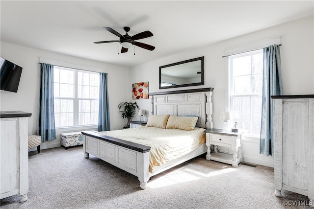 bedroom featuring multiple windows, carpet, and ceiling fan