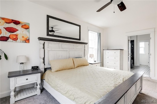 carpeted bedroom featuring a ceiling fan and baseboards