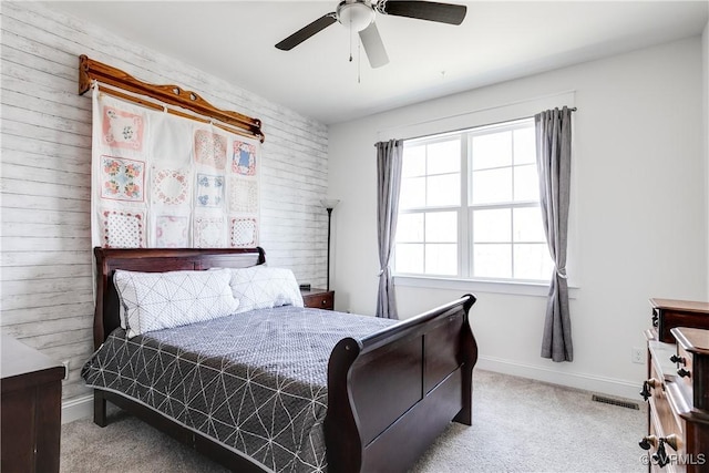 bedroom with carpet flooring, ceiling fan, baseboards, and visible vents