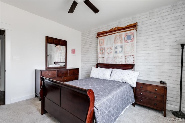 bedroom featuring ceiling fan, baseboards, and light carpet