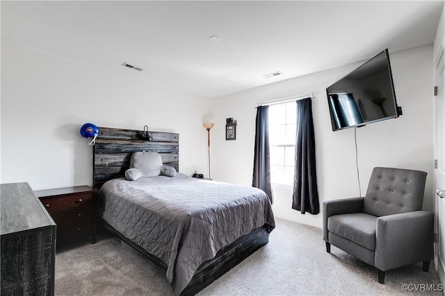 bedroom with visible vents and carpet flooring