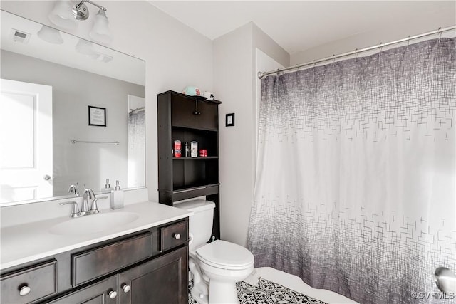 full bath with vanity, toilet, and visible vents