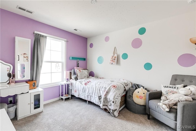 bedroom with visible vents, baseboards, and light colored carpet