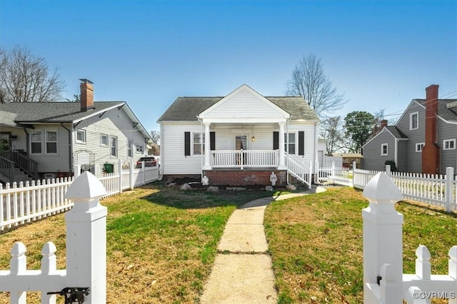 bungalow-style house with a residential view, a porch, fence private yard, and a front lawn