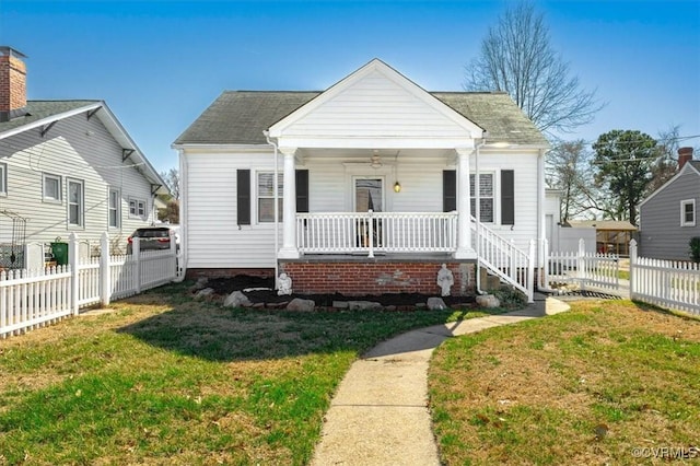 bungalow with a porch, a front lawn, and fence