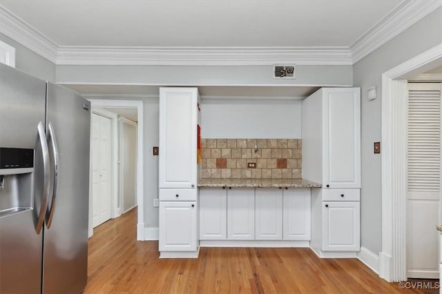 kitchen featuring white cabinets, stainless steel fridge with ice dispenser, and light wood finished floors