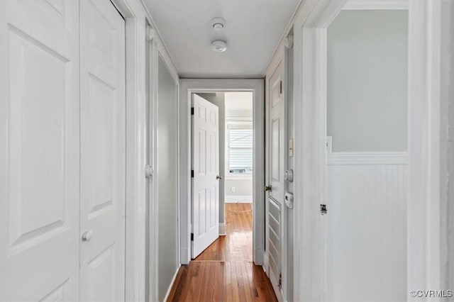 hallway with baseboards and dark wood-style flooring