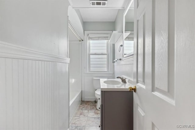 full bath with visible vents, toilet, marble finish floor, washtub / shower combination, and vanity