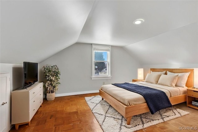 bedroom with baseboards and vaulted ceiling