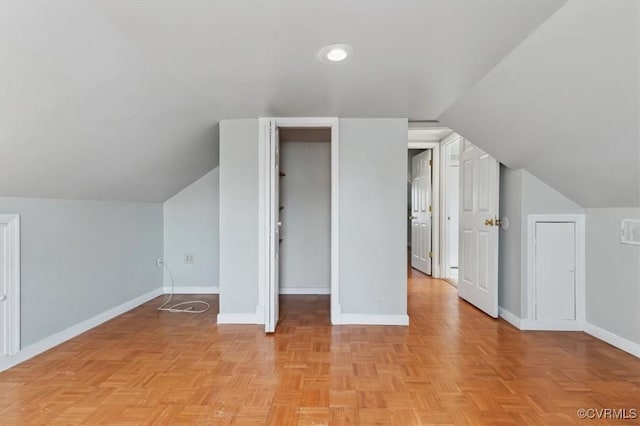 additional living space with lofted ceiling and baseboards