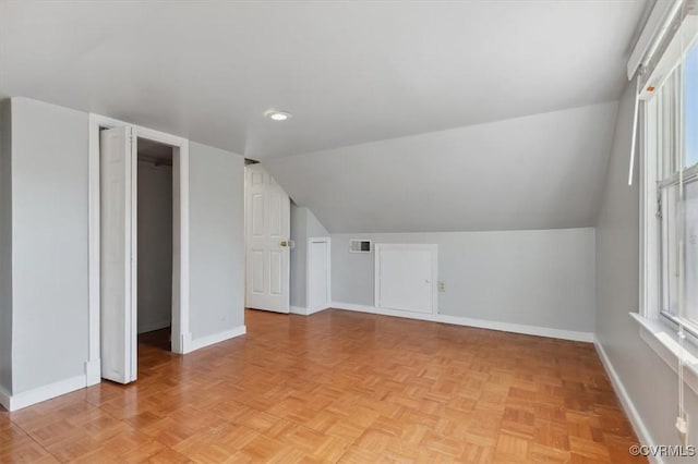 additional living space with a wealth of natural light, visible vents, and baseboards