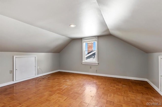 additional living space featuring lofted ceiling and baseboards