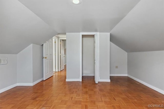 bonus room featuring baseboards and vaulted ceiling