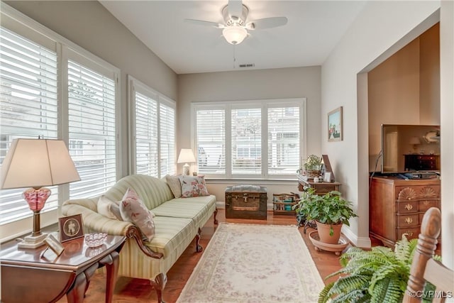 sunroom with visible vents and ceiling fan