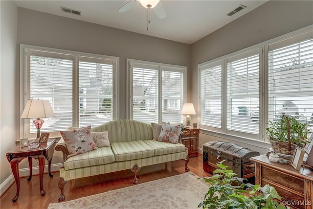 sunroom / solarium featuring visible vents and ceiling fan