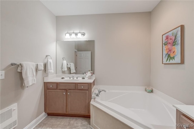 bathroom with vanity, a garden tub, and baseboards