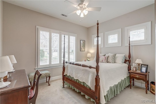 bedroom featuring visible vents, light colored carpet, baseboards, and ceiling fan