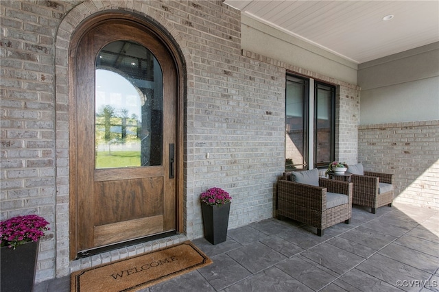 property entrance featuring brick siding