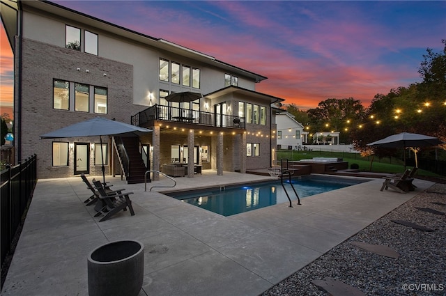 view of pool with stairs, a patio, a fenced backyard, and a hot tub