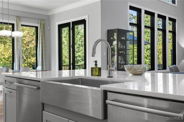 kitchen with stainless steel dishwasher, crown molding, hanging light fixtures, and light stone countertops