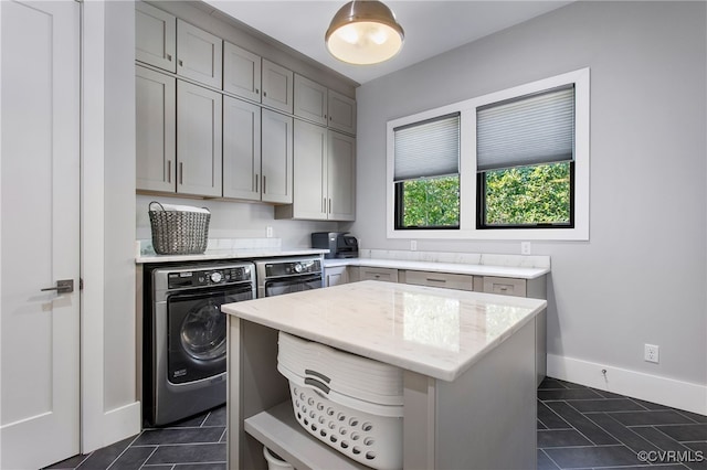 kitchen featuring gray cabinetry, oven, dark tile patterned flooring, washer and clothes dryer, and open shelves