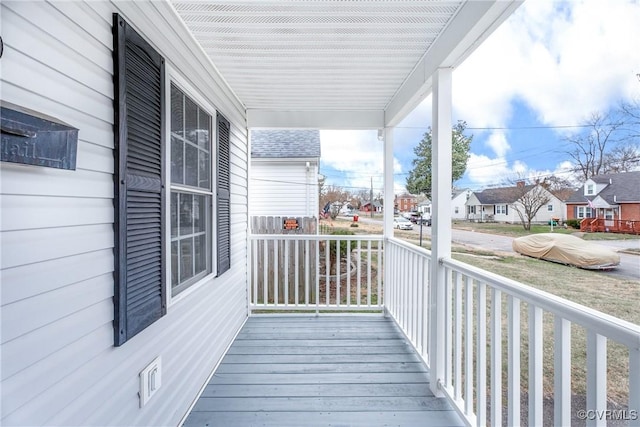 deck with covered porch and a residential view