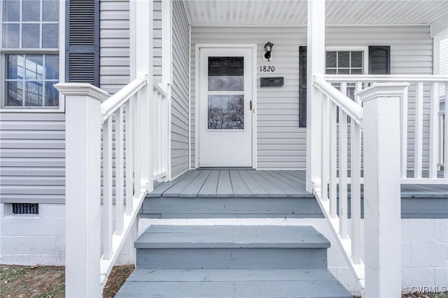 doorway to property featuring crawl space and covered porch