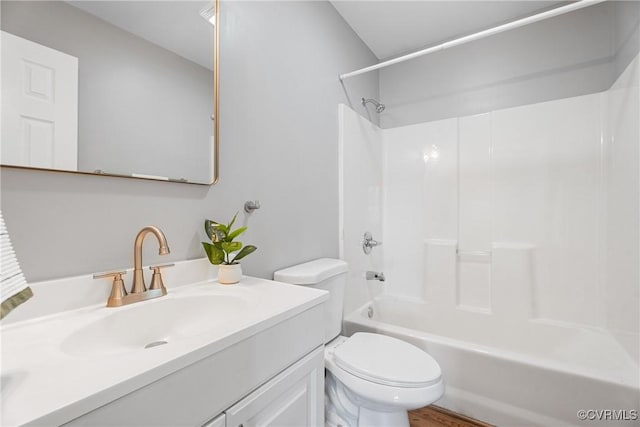 bathroom with bathing tub / shower combination, toilet, and vanity