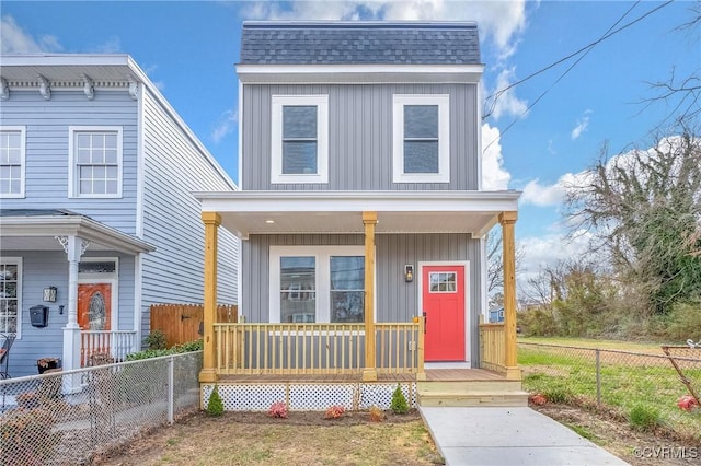 view of front of home featuring covered porch, board and batten siding, a shingled roof, and fence