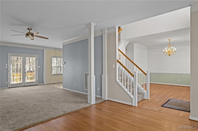 spare room featuring stairway, wood finished floors, visible vents, and ornamental molding