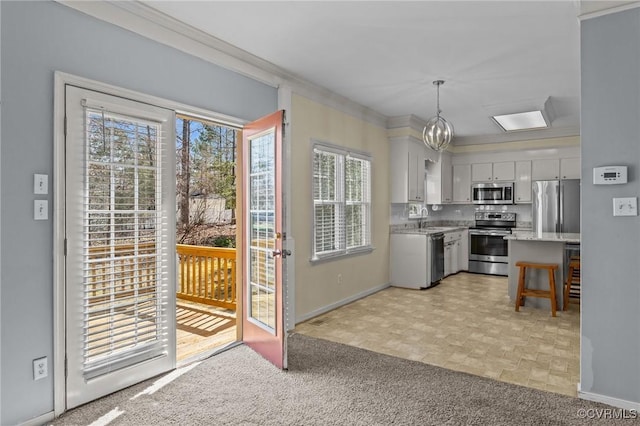 kitchen with a sink, stainless steel appliances, and ornamental molding