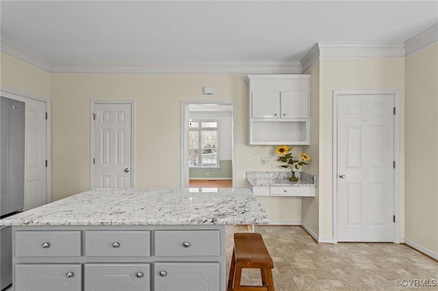 kitchen with baseboards, ornamental molding, light stone counters, gray cabinets, and open shelves