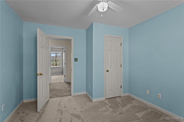 unfurnished bedroom with baseboards, carpet floors, and ceiling fan