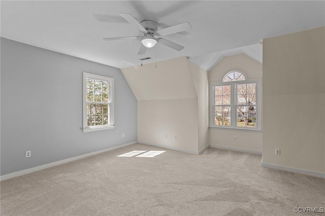 additional living space with carpet flooring, lofted ceiling, and plenty of natural light