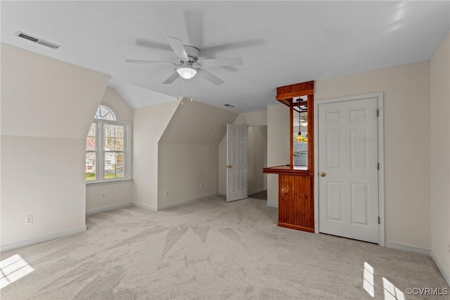 additional living space with visible vents, baseboards, carpet, and lofted ceiling