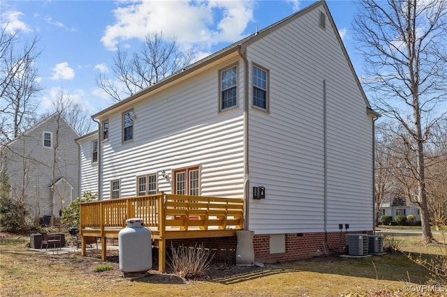 rear view of house with crawl space, central AC unit, and a deck