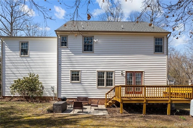 rear view of property featuring a deck and a patio