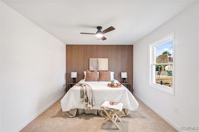 carpeted bedroom featuring a ceiling fan and baseboards