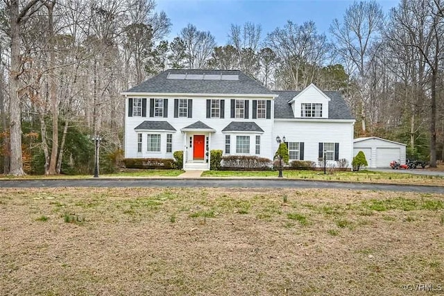 colonial-style house with an outbuilding and a garage