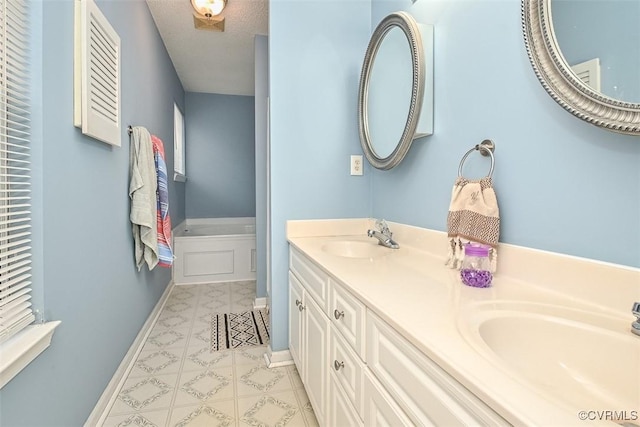 full bath featuring baseboards, a sink, and a garden tub