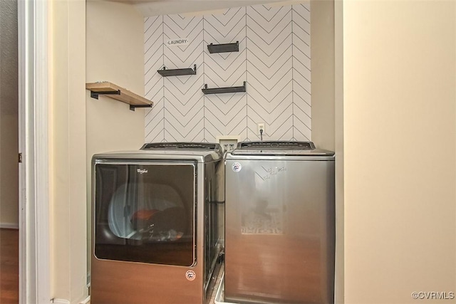 clothes washing area with independent washer and dryer and laundry area