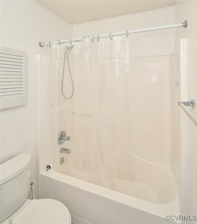 bathroom with shower / tub combo and toilet